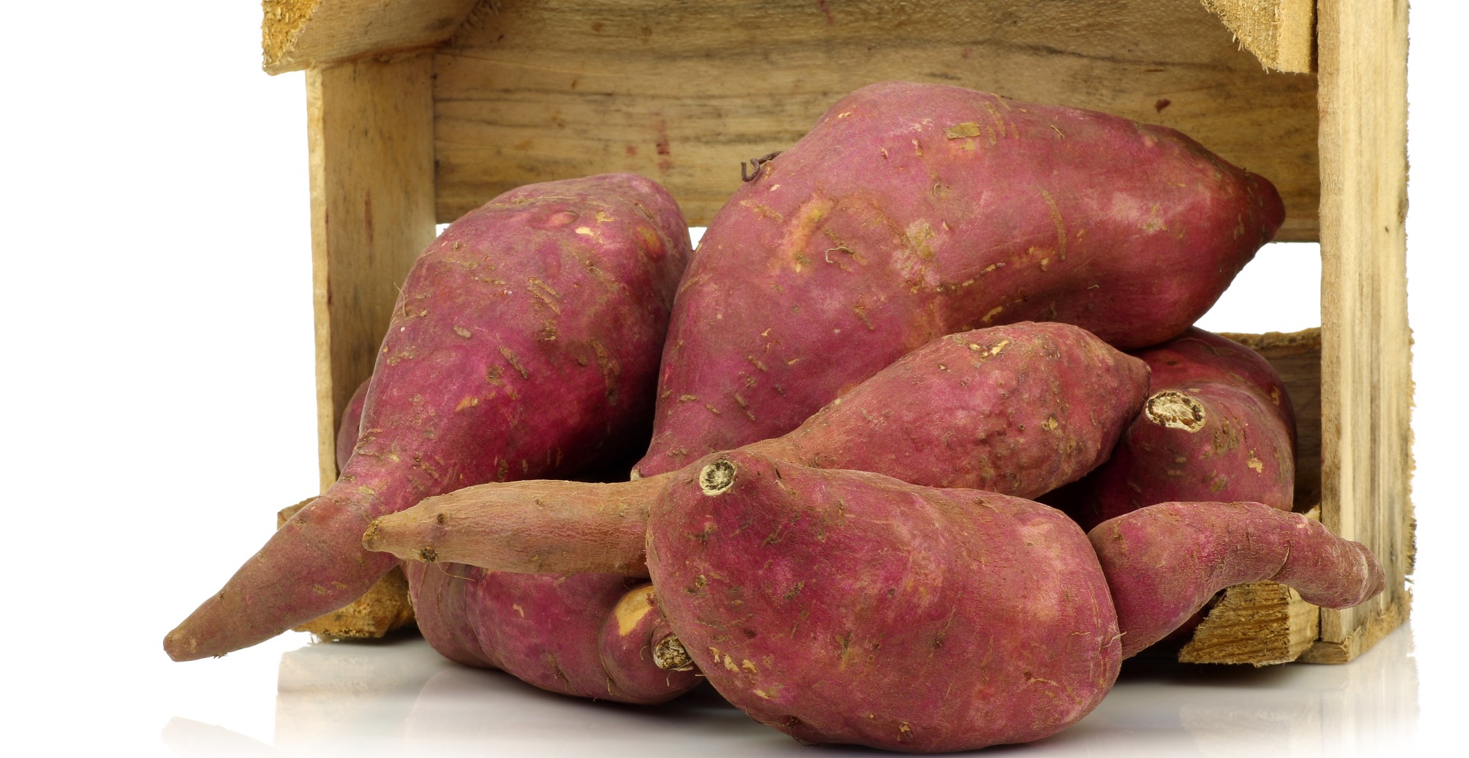 Bunch of sweet potatoes in a wooden crate